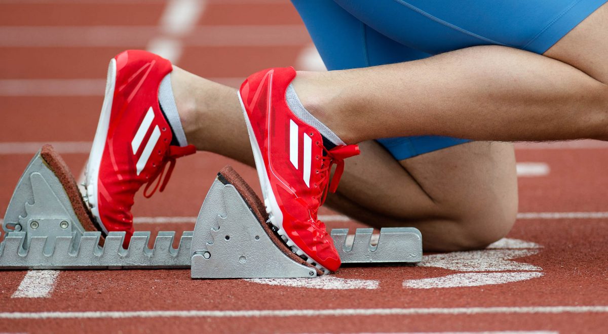 Detailed view of a sprinter in the starting blocks